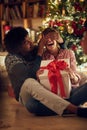 Romantic surprise for Christmas holiday Ã¢â¬âmale and female with present Royalty Free Stock Photo